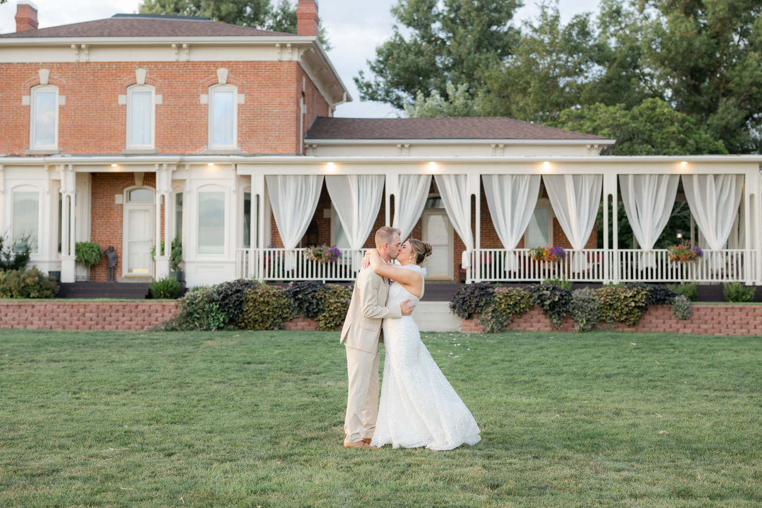 bride and groom kissing at their wedding at the 1868 farmhouse venue